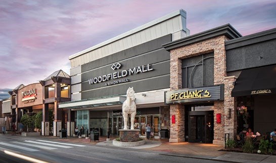Exterior view of Woodfield Mall's main entrance featuring PF Chang's restaurant and decorative horse statue.